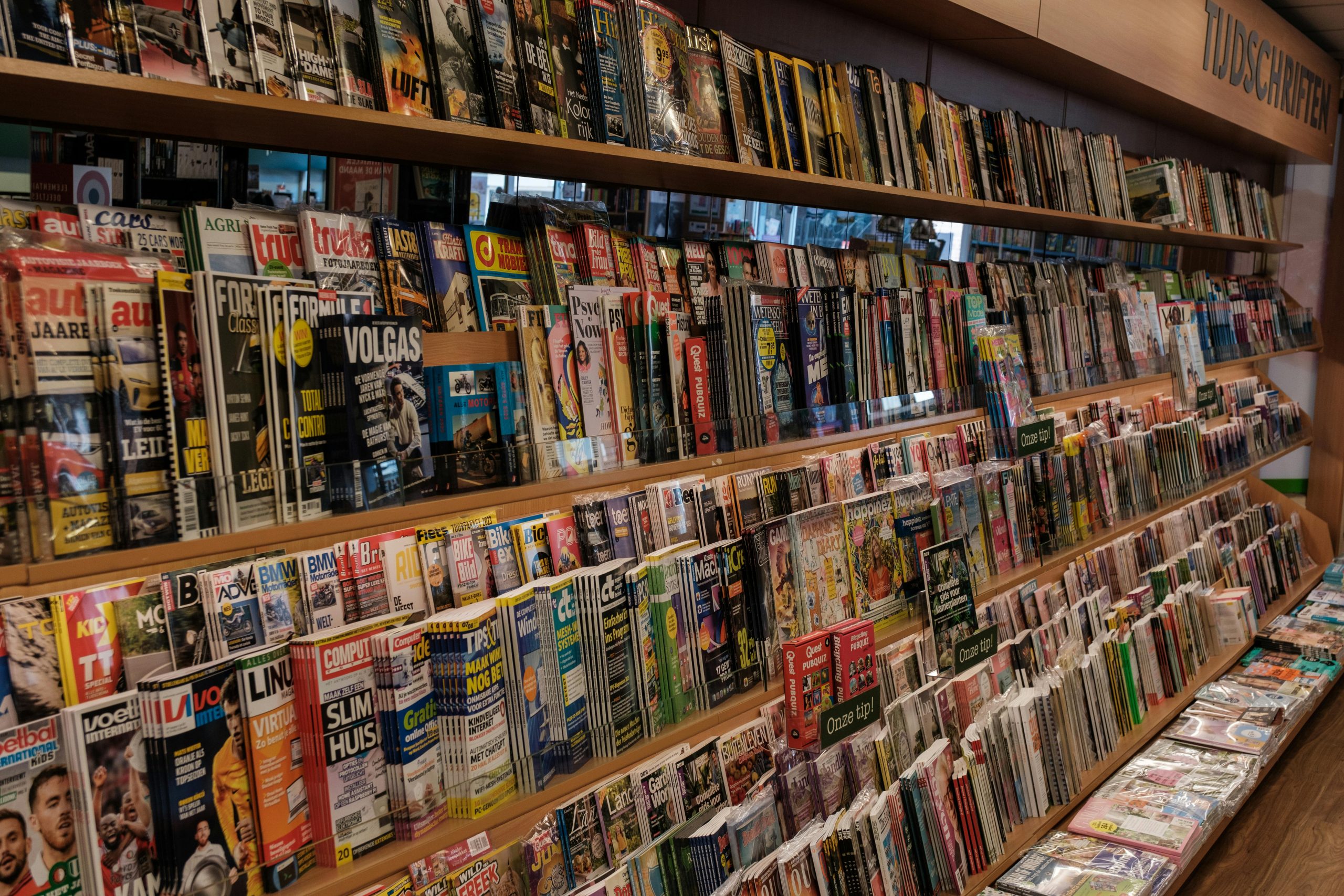 Colorful array of magazines in a bookstore in Amsterdam, showcasing a variety of topics.