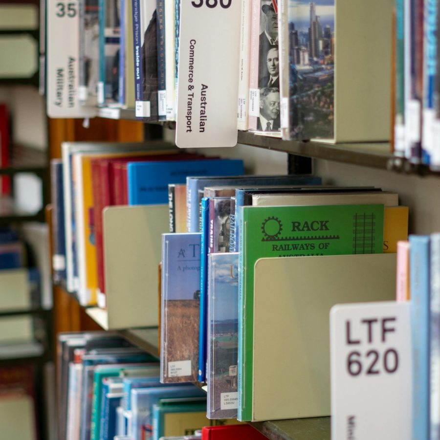 Close-up view of library shelves with various books, Melbourne, Australia.